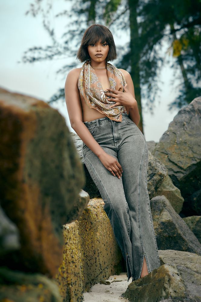 Half portrait of girl sitting on stone rock