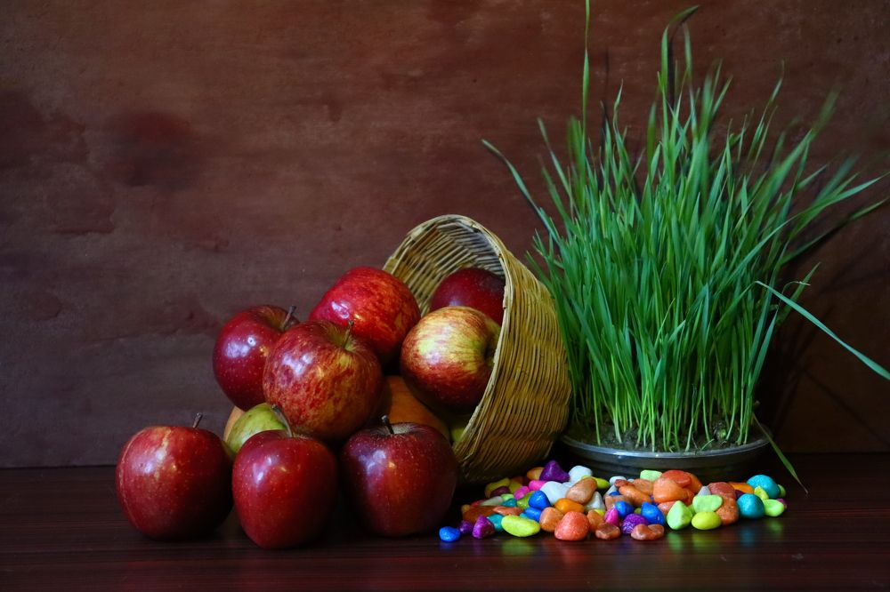 RED APPLES FALLING FROM BASKET