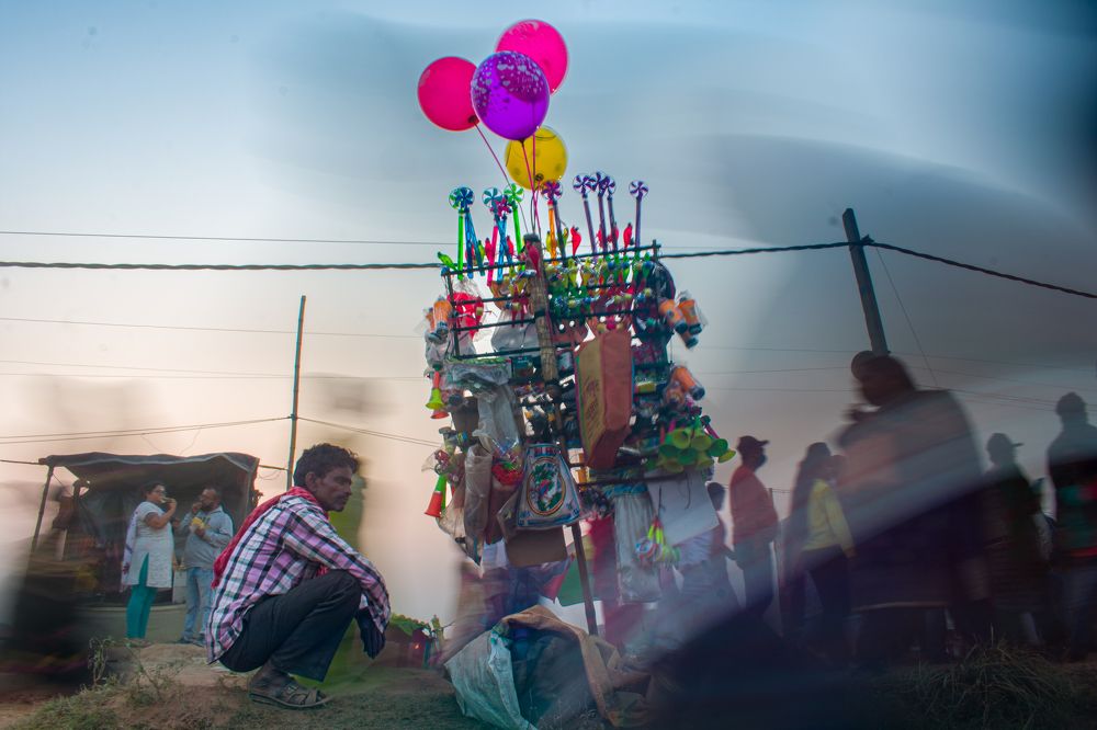 A lone hawker among all those busy at the fair.