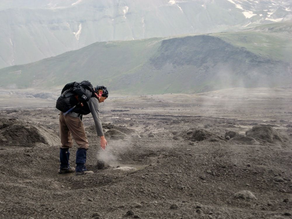 Девушка-вулканолог изучает свежий пепел