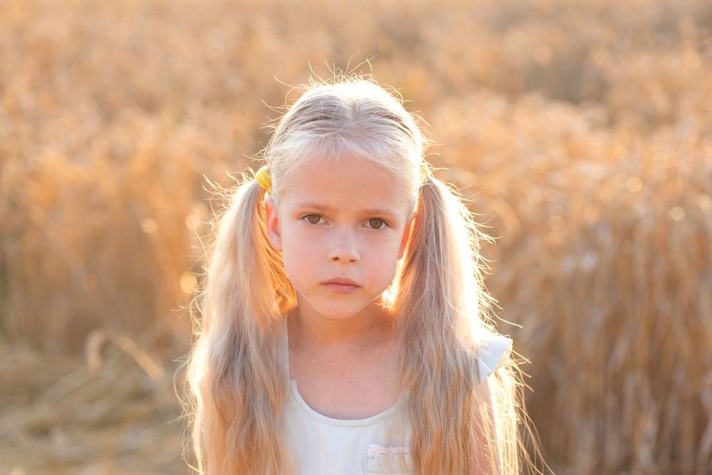 Девочка на фоне поля на закате