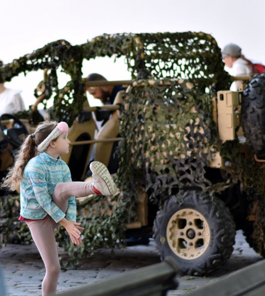 Dancing girl in front of a recruiting car...