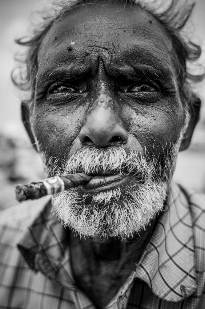Old man smoke cigarettes..