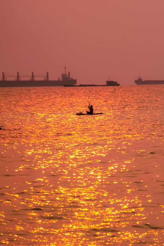 Man Rowing Boat In The Sea