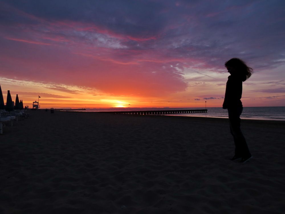 Silhouette of a girl on the background of dawn