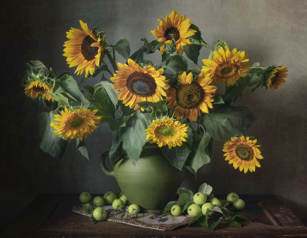 Still life with sunflowers and green apples
