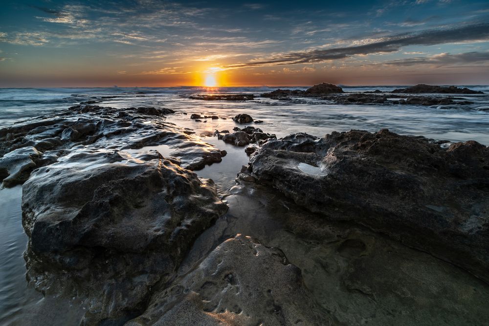 Sunset over rocky beach
