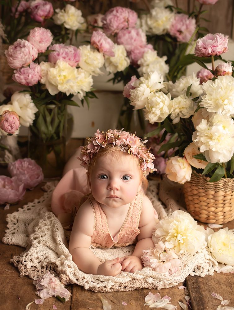 A child and peonies.