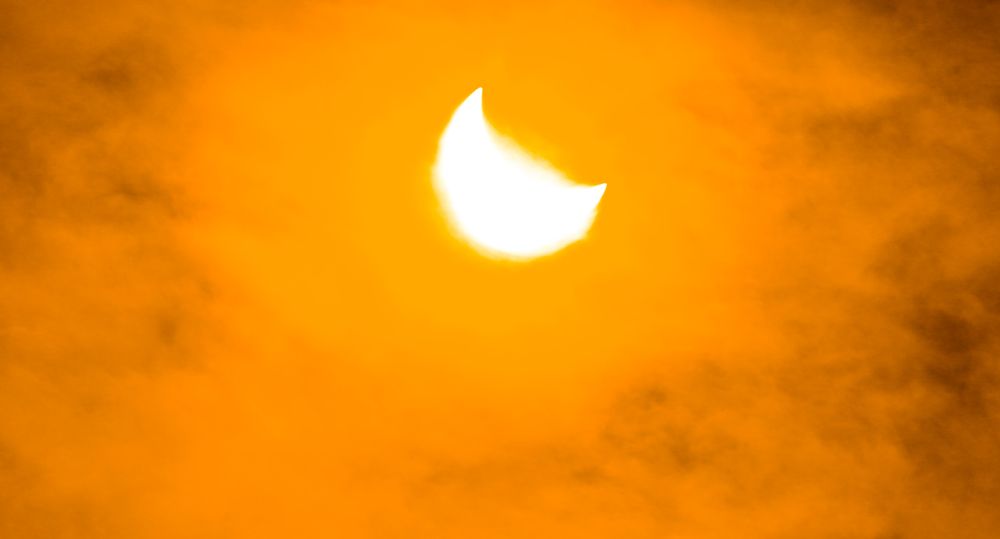 Solar eclipse in cloudy haze