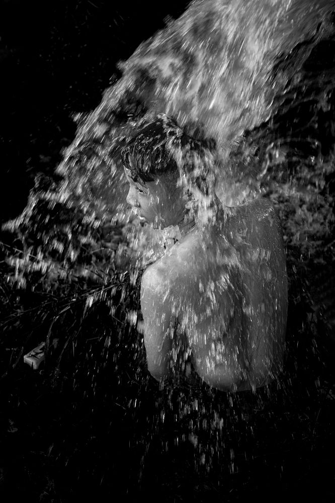 Bathing under the waterfall