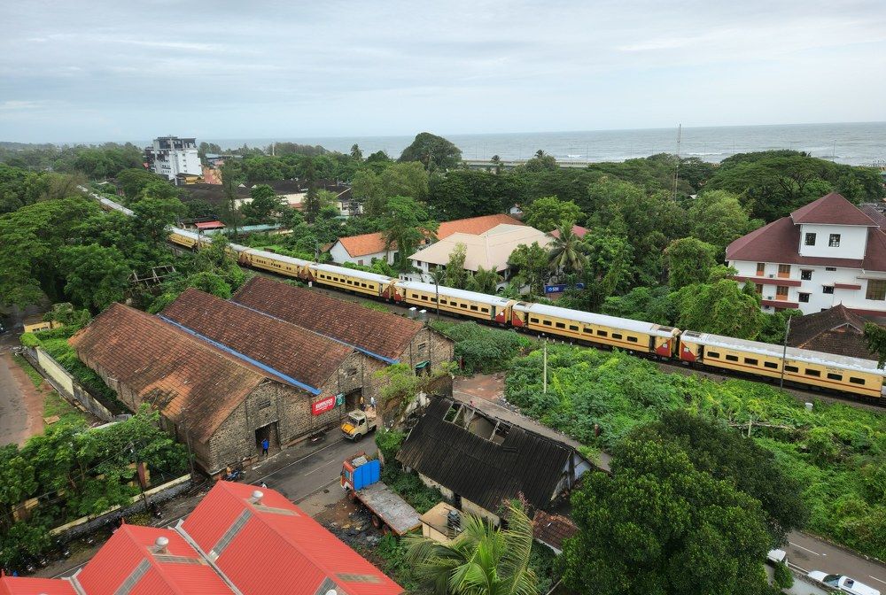 Train moving through Alleppey town Kerala India