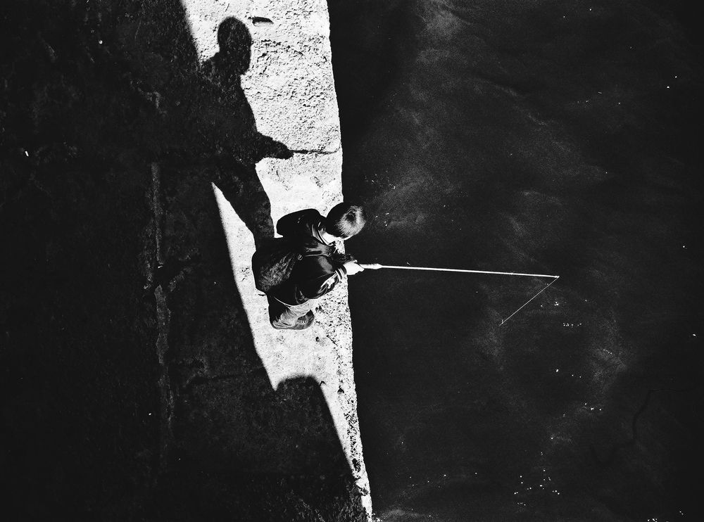Small fisherman catches the stars at the edge of the world