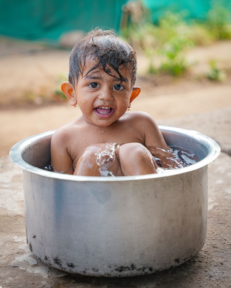 Little kid enjoying his bath.