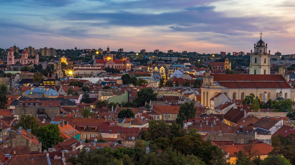 Panoramic view of Vilnius townscape against sky at sunset