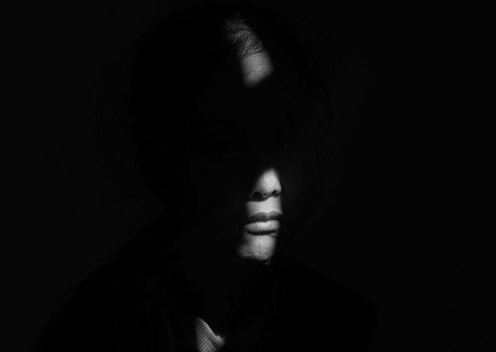 Sunny Elegance: A Glimpse of Sunlight Illuminating Half of Her Face