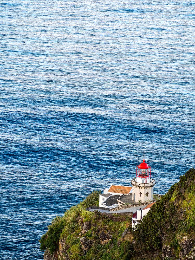 a lighthouse in front of the great ocean