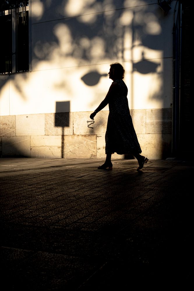 Backlight of woman on the street