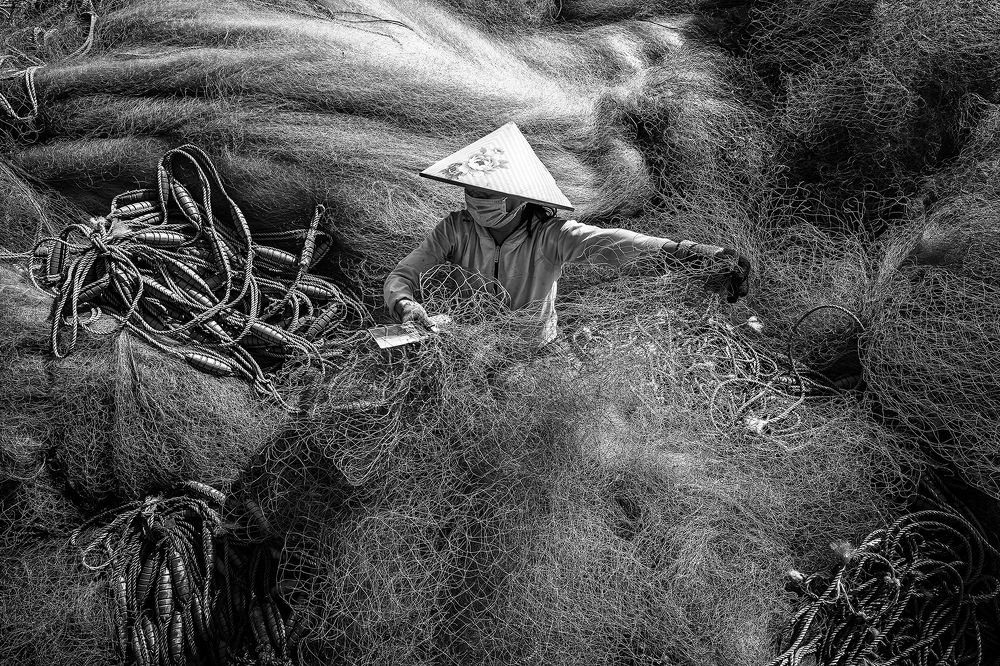 Vietnamese Woman Sitting Repair Fishing Net