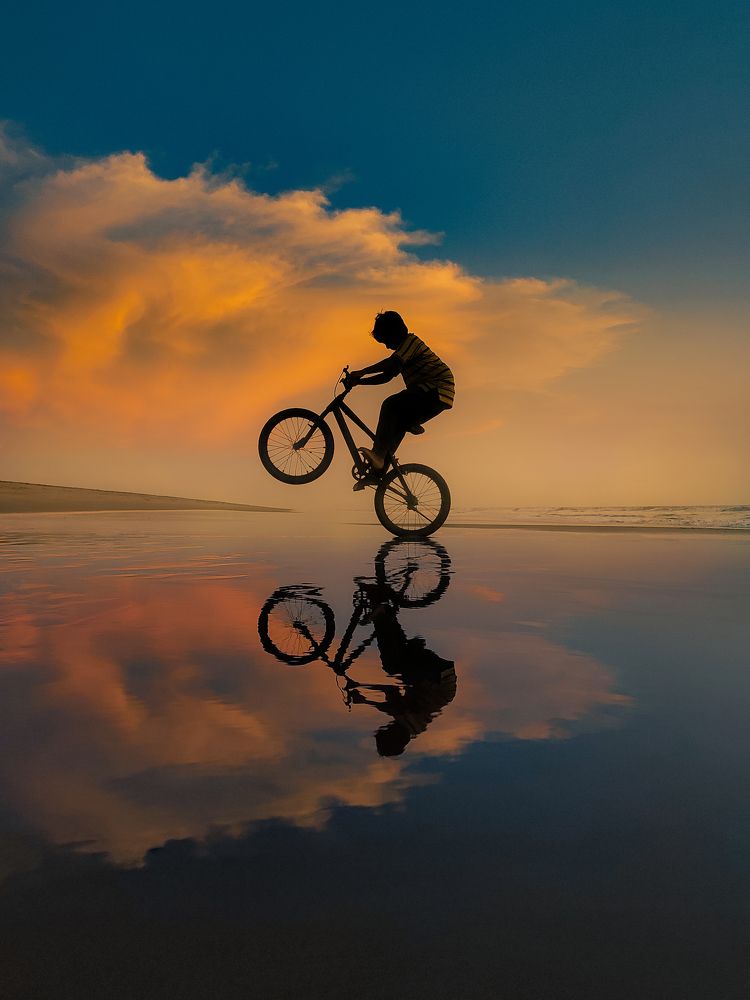 Pedaling through sandy shores, chasing shadows of dedication