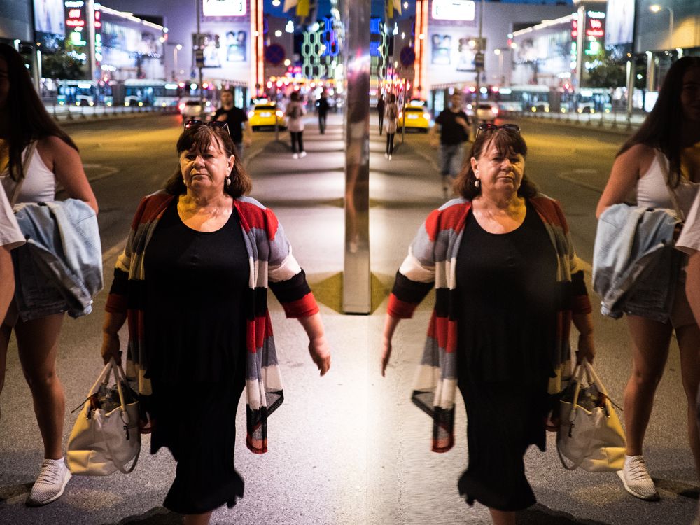 The Double Reflection of a Woman in the Illuminated City
