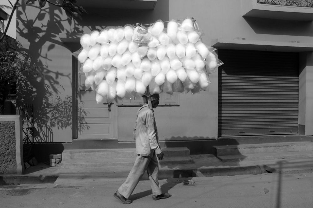Cotton candy seller in search of customers.