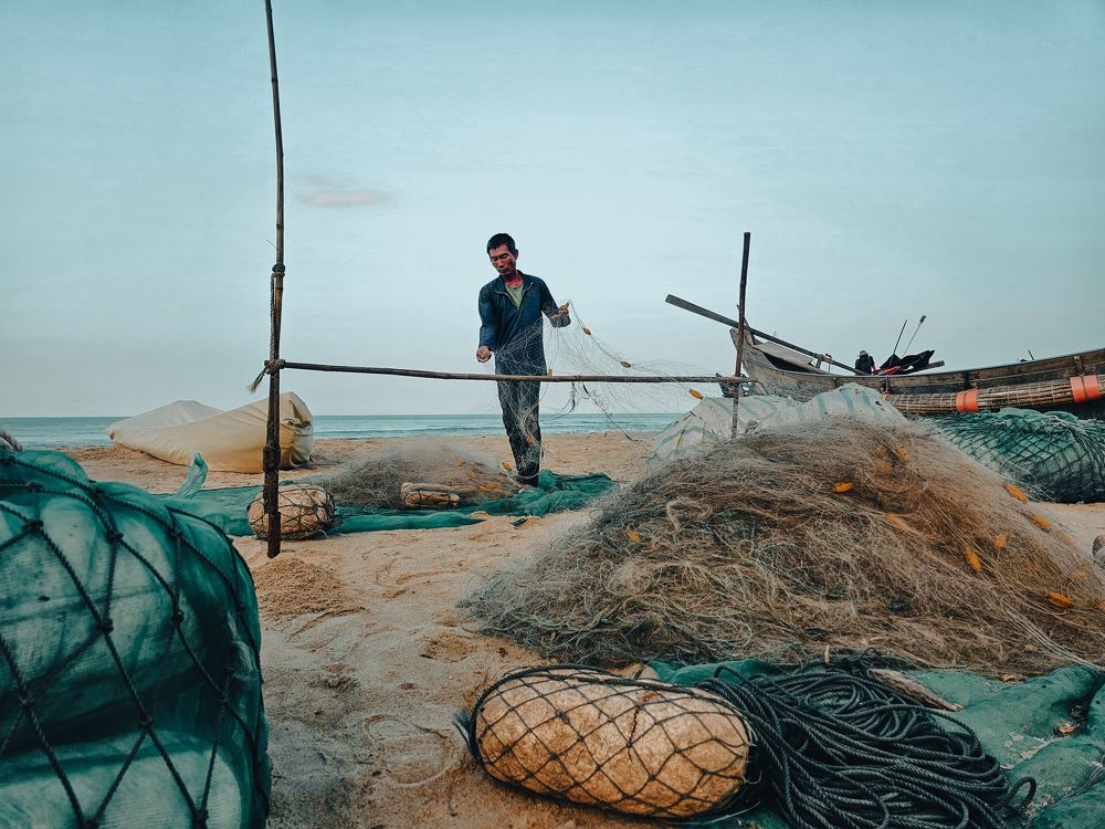 Fishermen working on the seashore