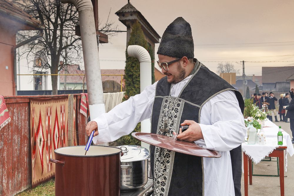 The priest prepares the mass wine