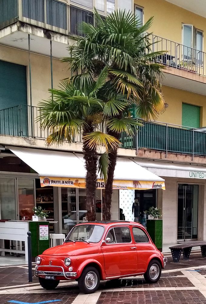 Red mini car on the street in Italy