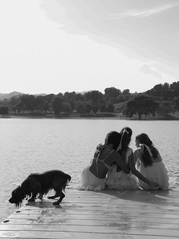 Three girlfriends on the river not counting the dog