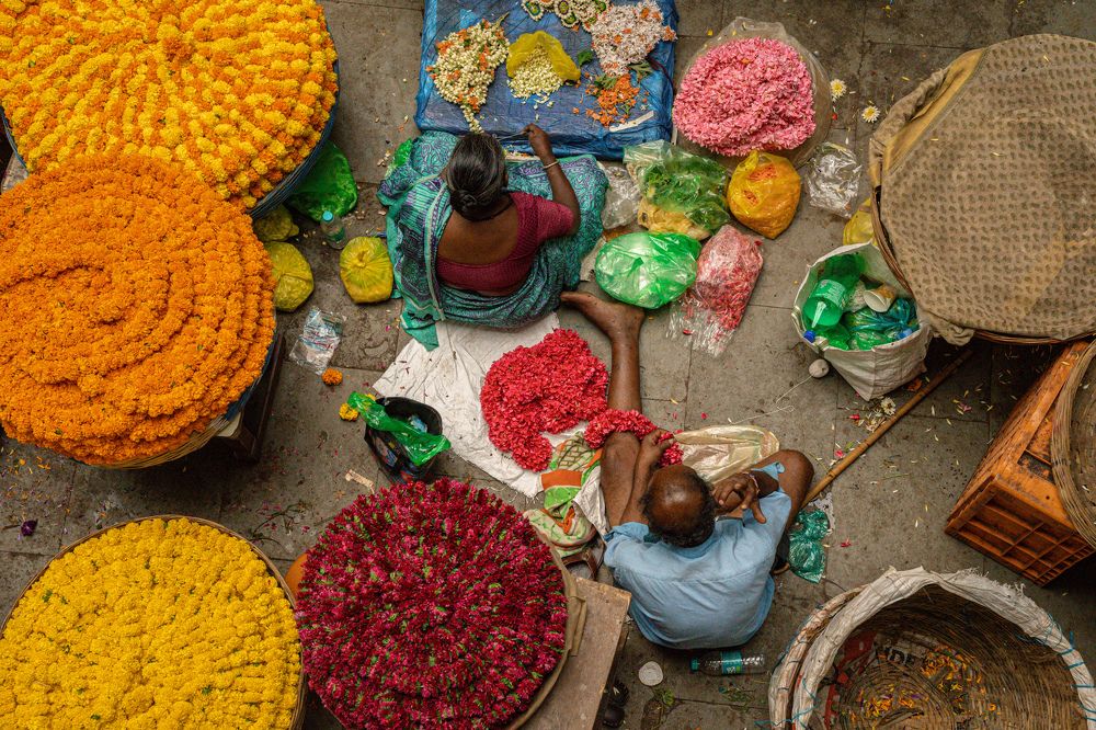 Couple working in the flower market for their daily needs