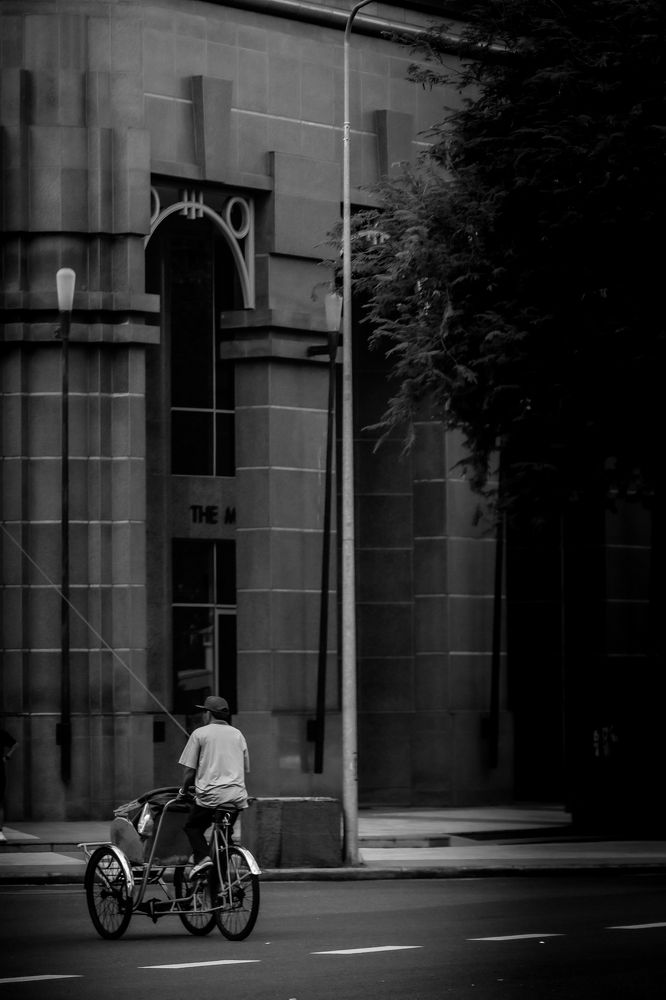 The old father runs a cyclo in Saigon.