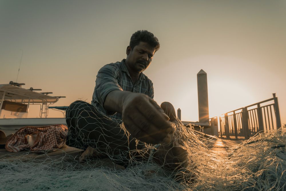 Threads of life, woven with the rising sun. Every knot holds a story, every cast a hope