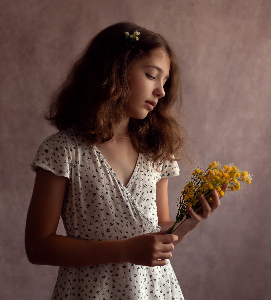 Sad girl with yellow flowers