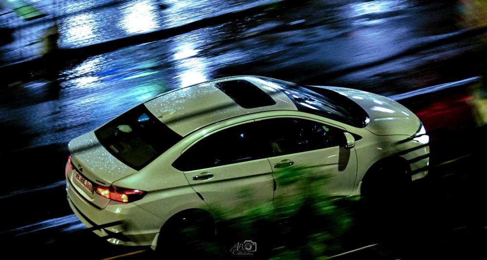 Sedan hot pursuit chase in rainy night