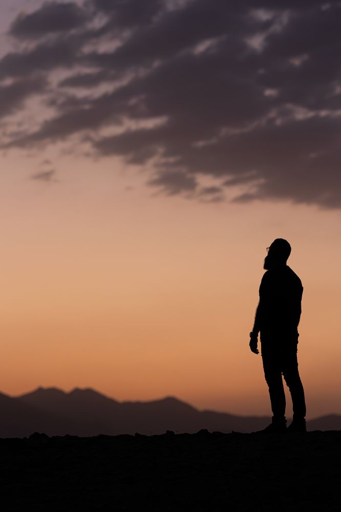 Lonely man in the mountains in shadow