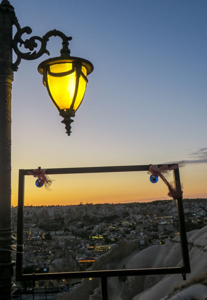 Yellow street lamp against sunset