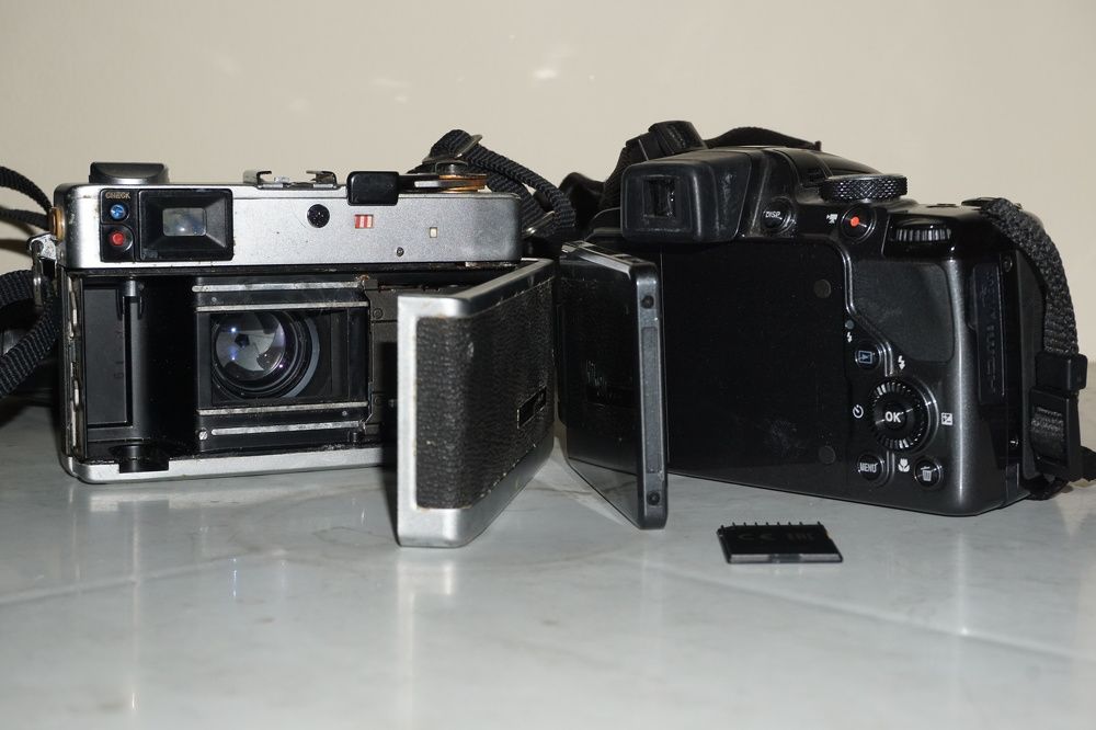 The camera uses roll film and the camera uses memory card.