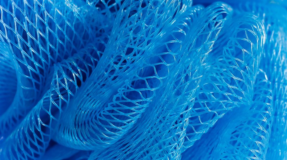 Part of a light blue nylon washcloth close up