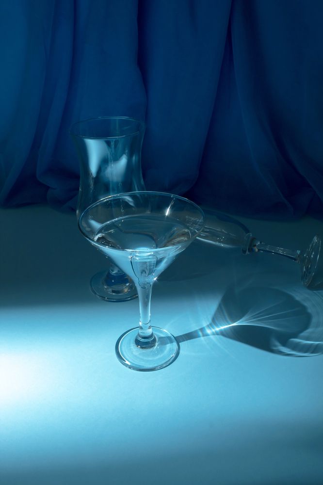 Blue glass on a blue background. Still life