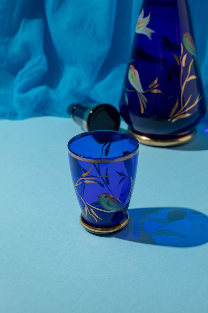 Blue glass on a blue background. Still life