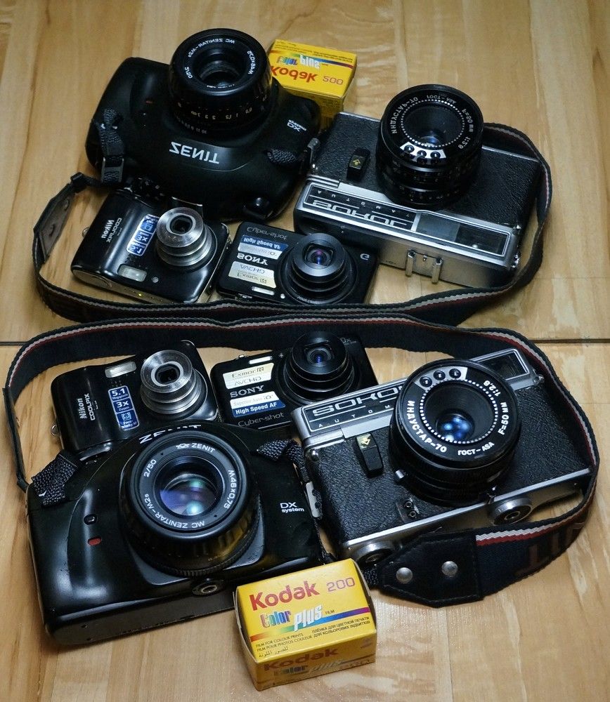 Vintage and modern cameras on a wooden background