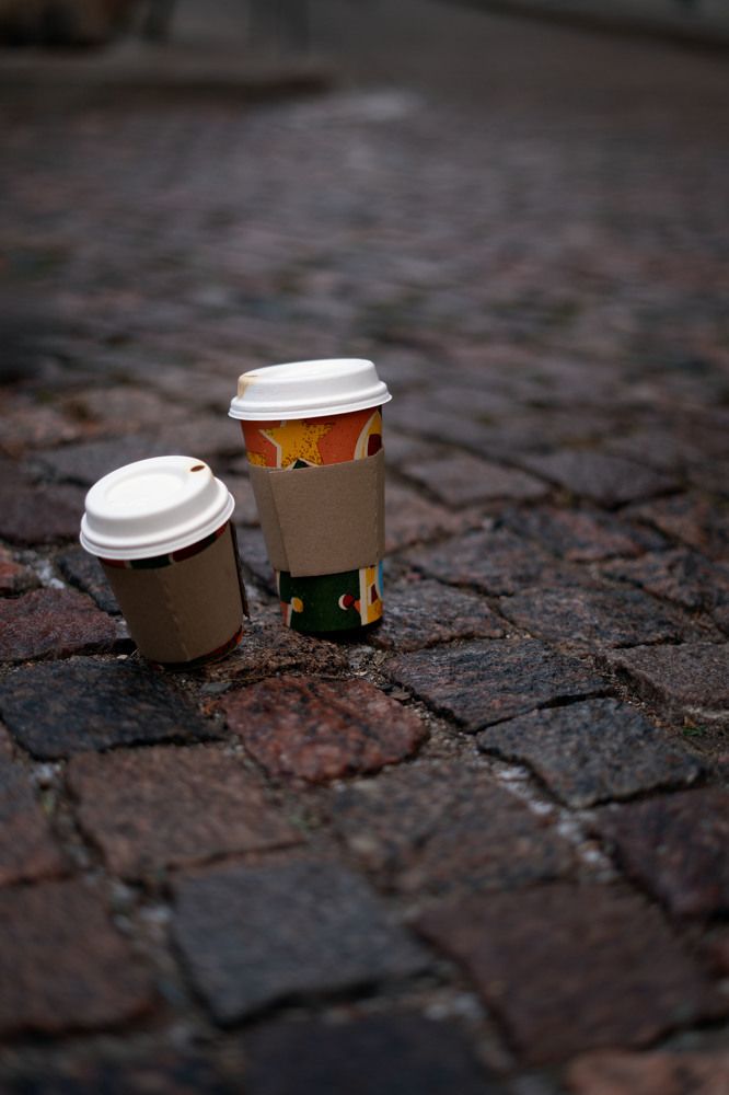 photo Exploring the Charm of Streets with Disposable Coffee Cups: A Visual Journey into Coffee Culture and the Essence of Urban Style and Creativity on Cobblestone Paths