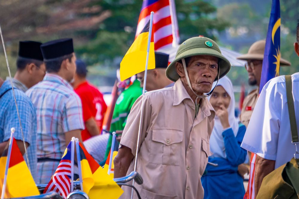 An elderly man enthusiastically celebrates Independence Day