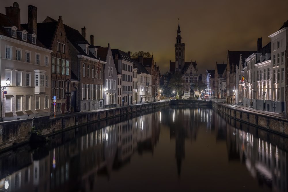 Canal and embankment of night Bruges