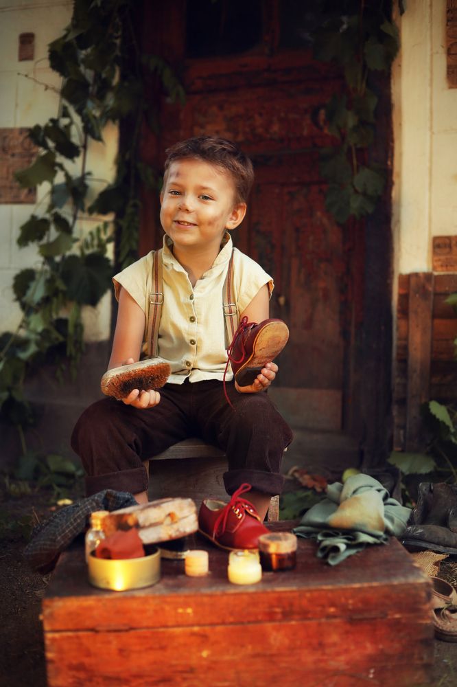 A cute little shoe shine boy.