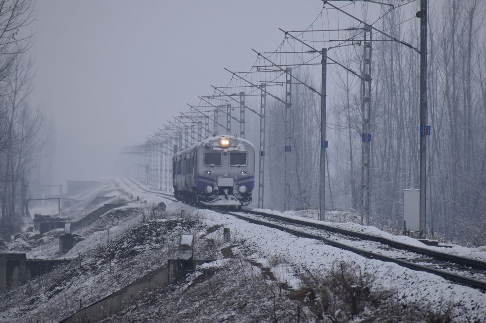 Train is running on the railway track, covered in a thick layer of snow
