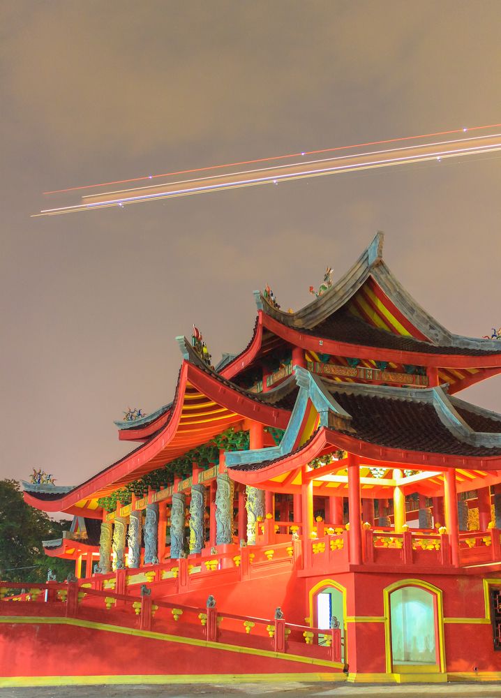 Airplane passes over Sam Poo Kong temple in Semarang city