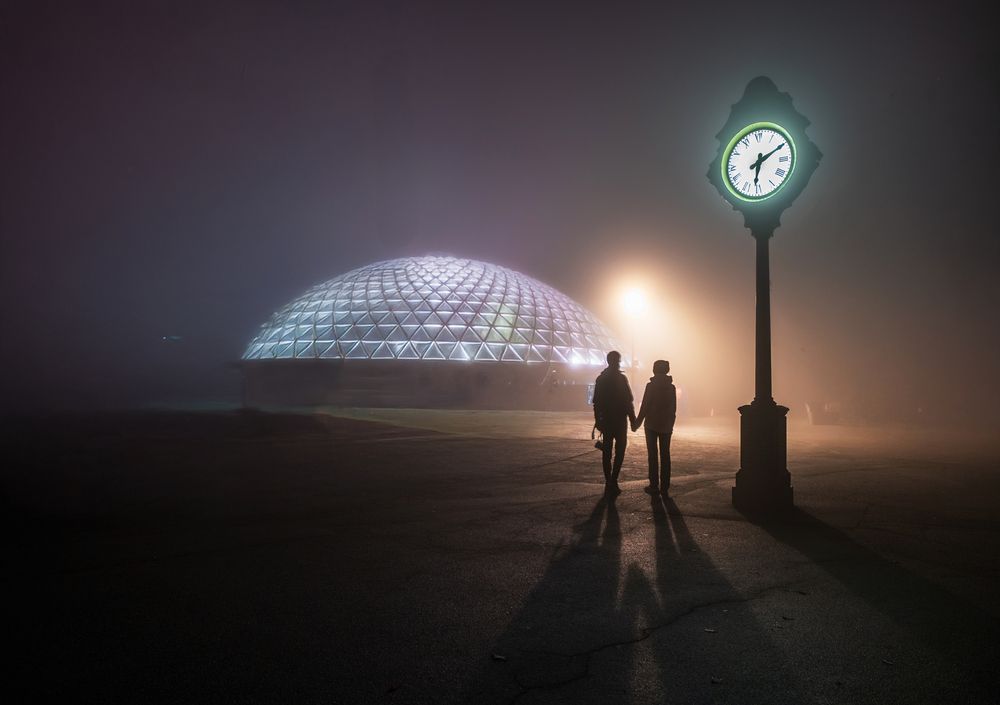 Street clock in a foggy night