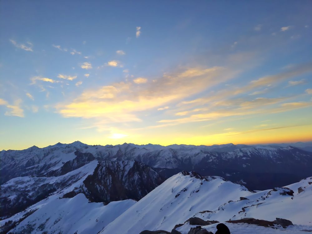 "Golden Twilight Over Snow-Capped Peaks"