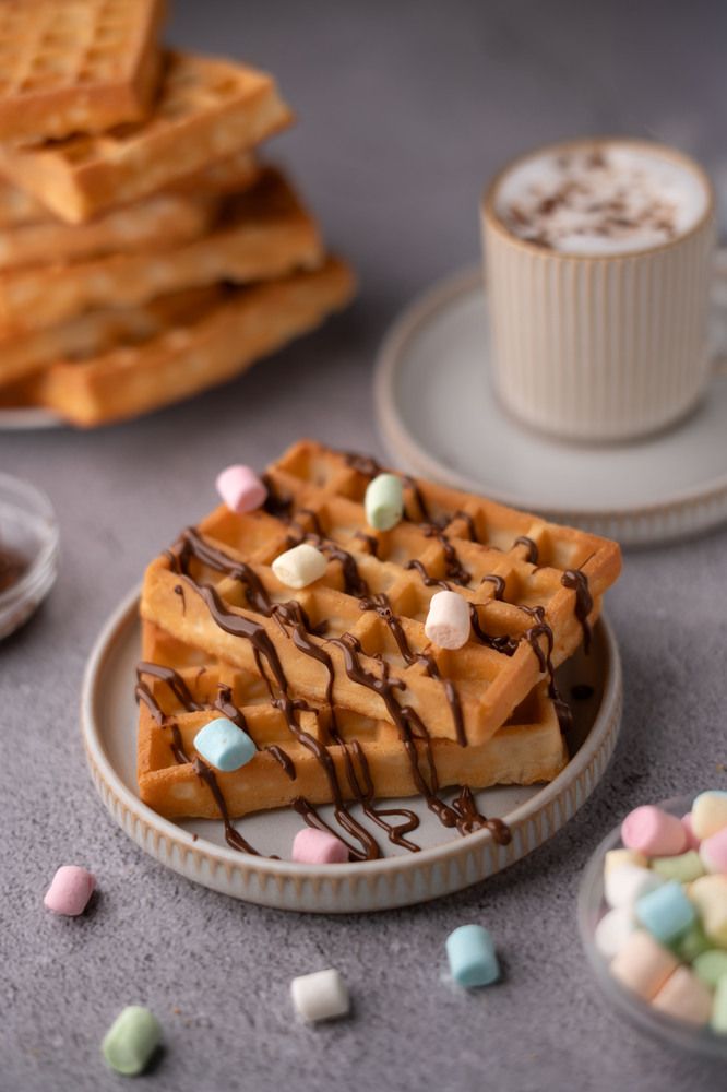 photo delicious golden waffles with rich chocolate drizzle and colorful marshmallows